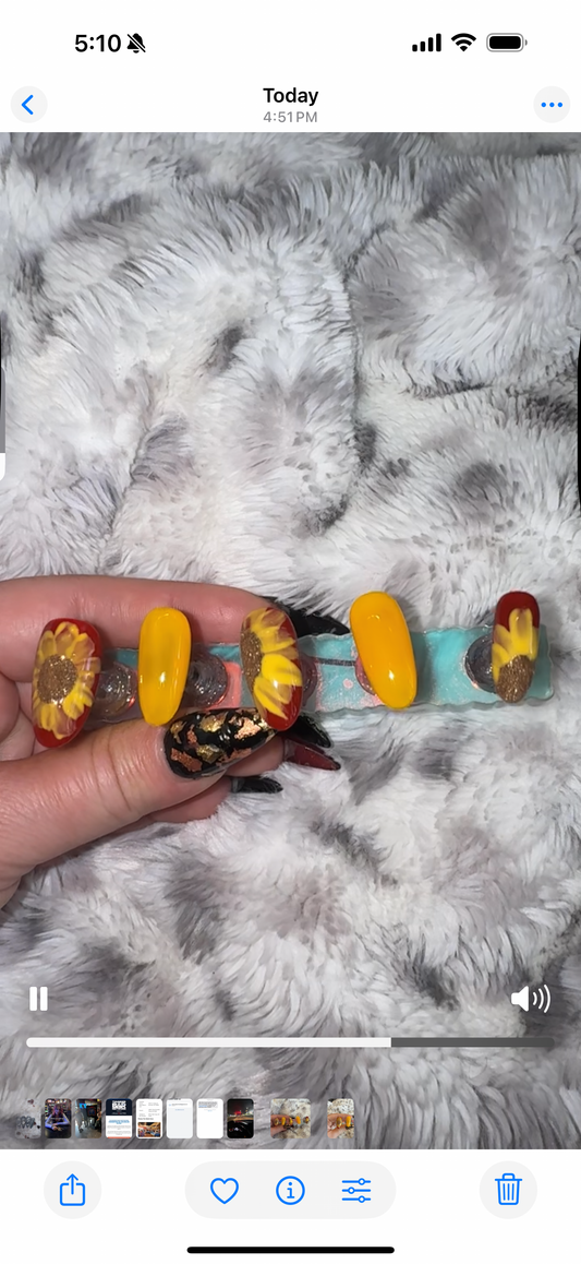 Colorful hair barrette held by a hand on a textured gray surface