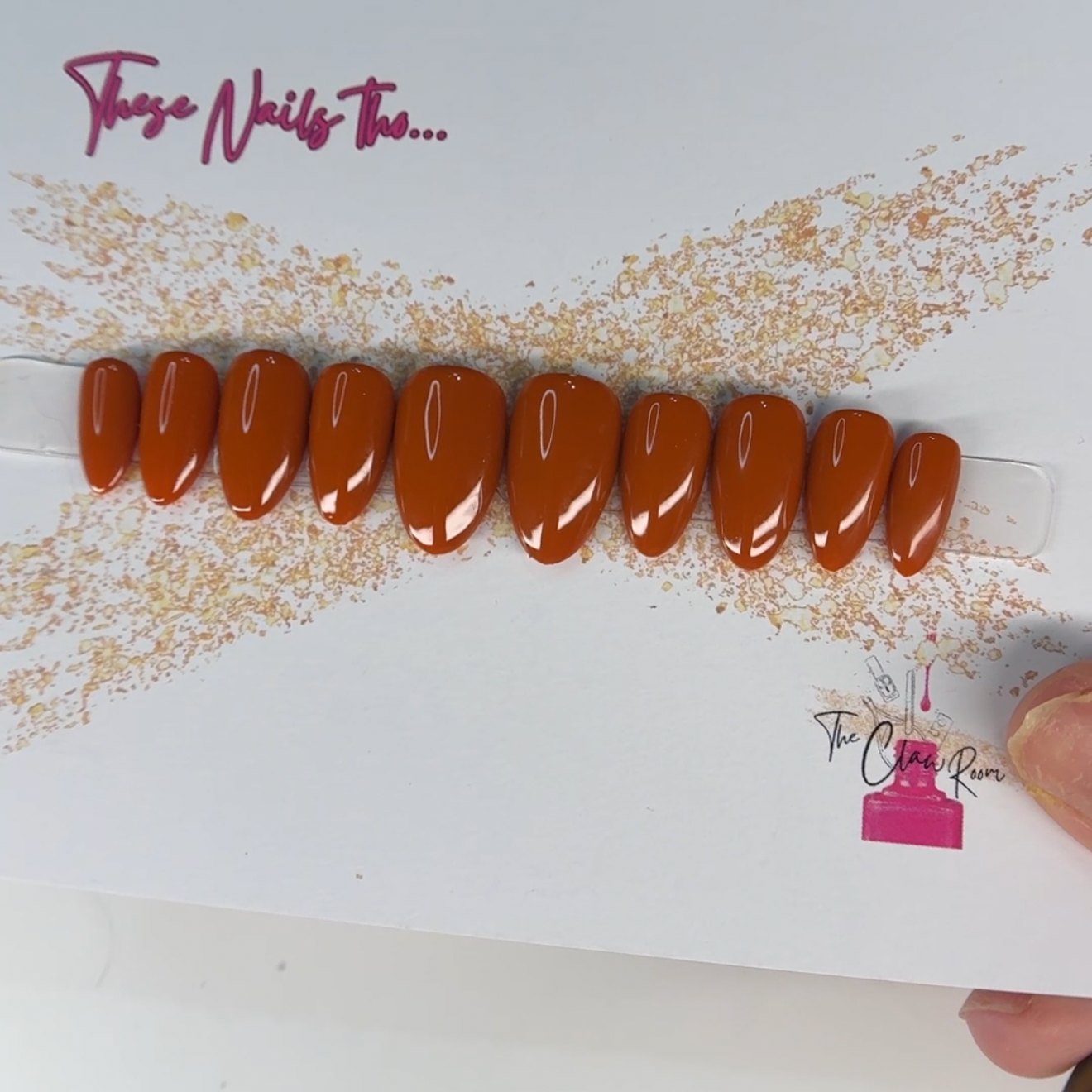 Set of brown nail extensions on a branded tray with 'Those Nails Too' visible.